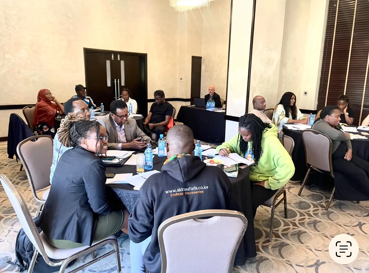 Participants gathered around tables for discussion and exchange during a Harbor of Hope activity